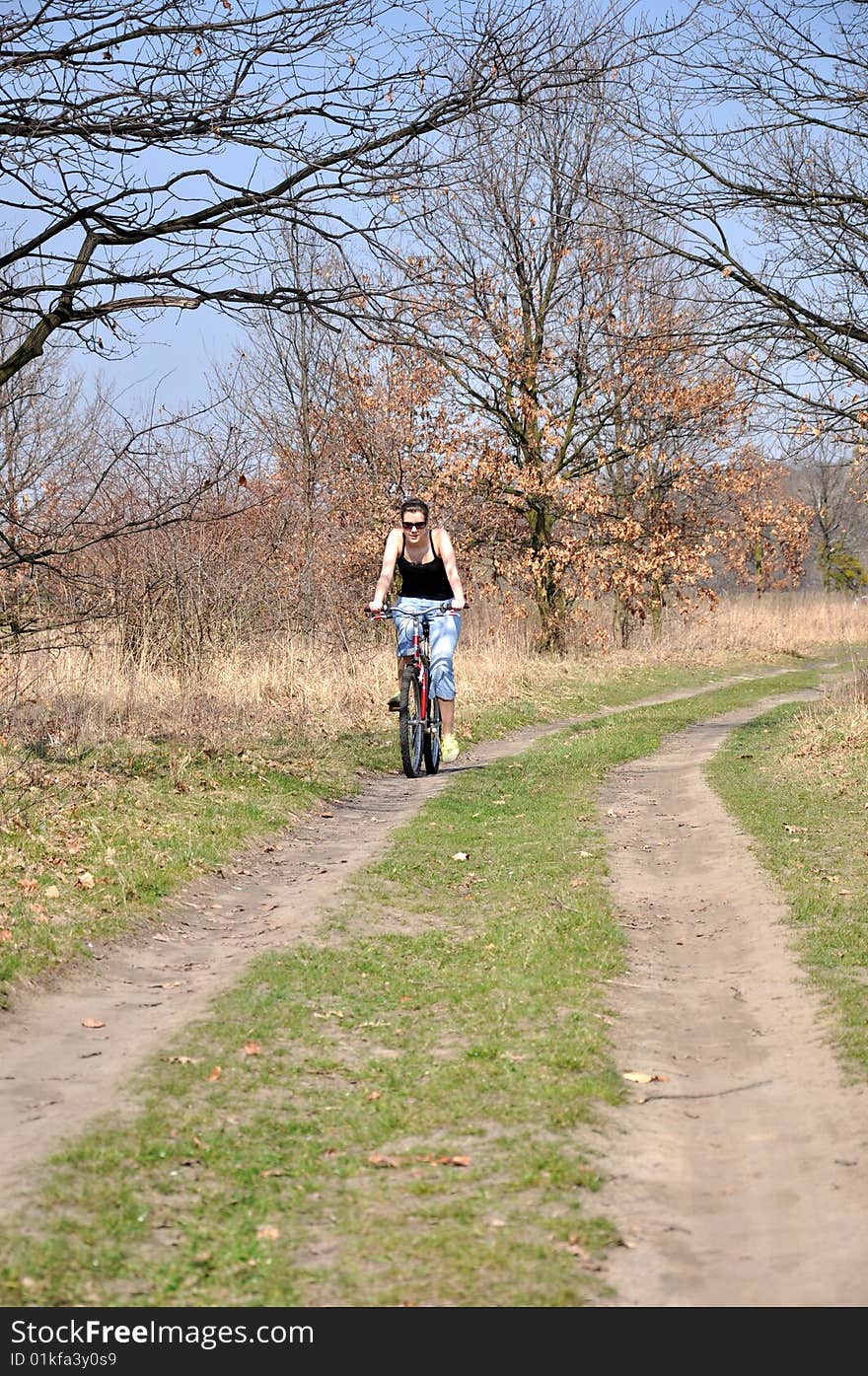 Girl riding a bike in beautiful spring scenery. Girl riding a bike in beautiful spring scenery