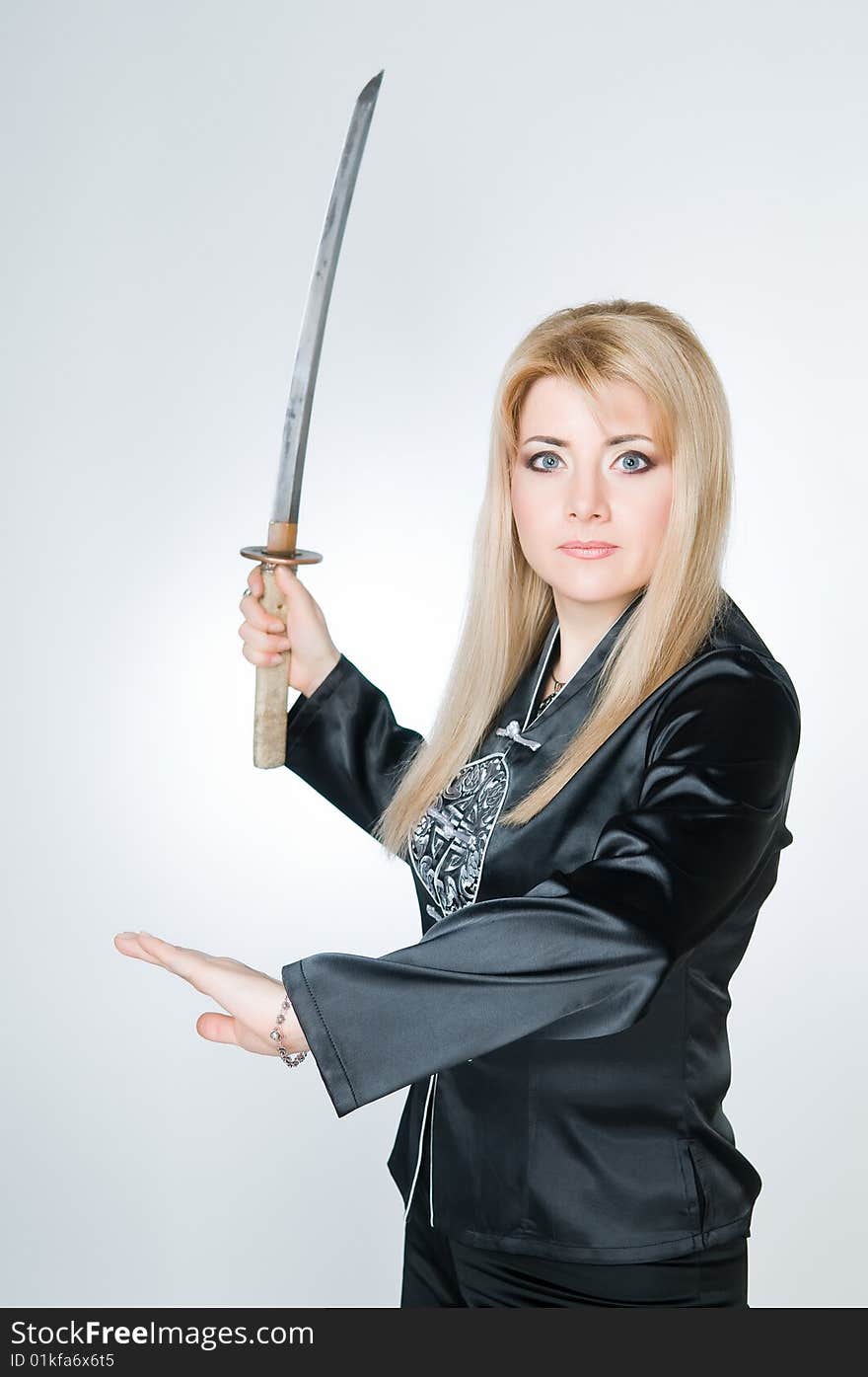 Portrait of woman with sword, studio shot