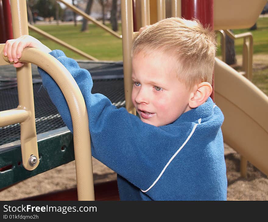 A color image of a young boy playing at the park. A color image of a young boy playing at the park.