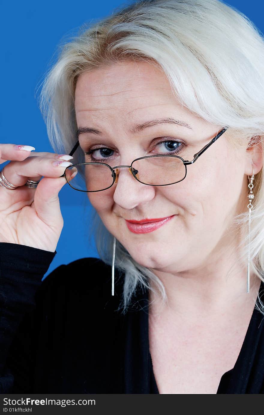 Woman looking over glasses