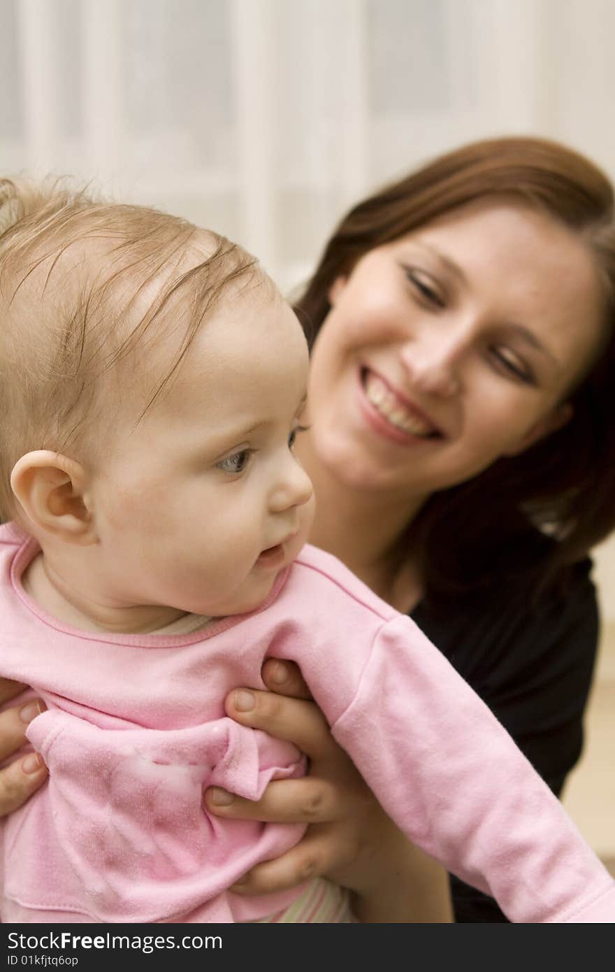 Mother and baby playing in home