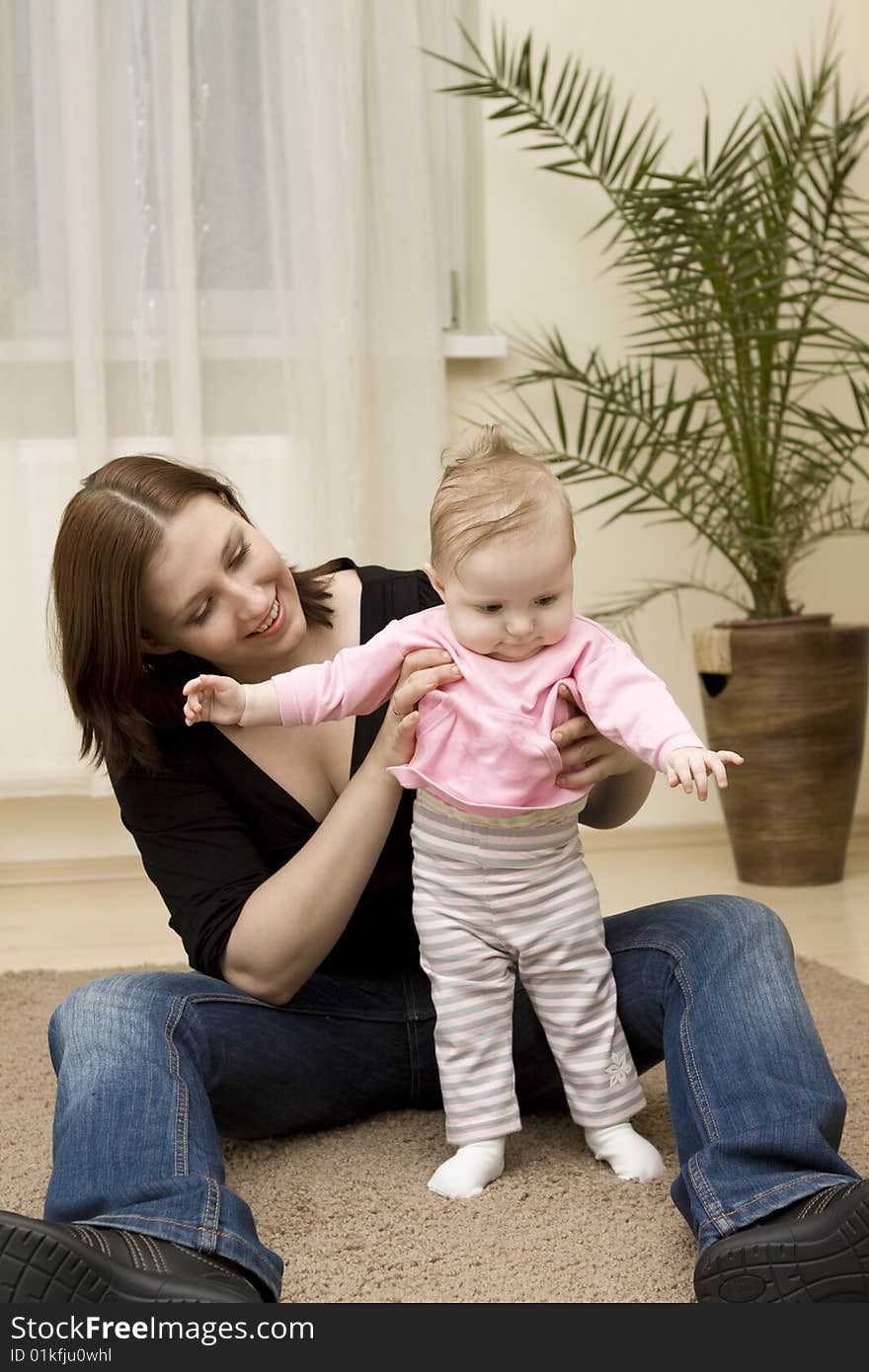 Mother and baby playing in home