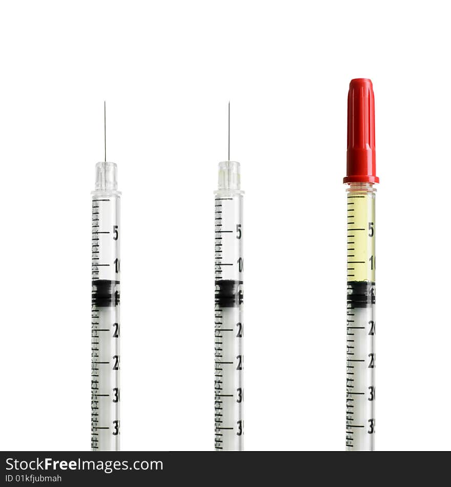 Three syringes isolated on white