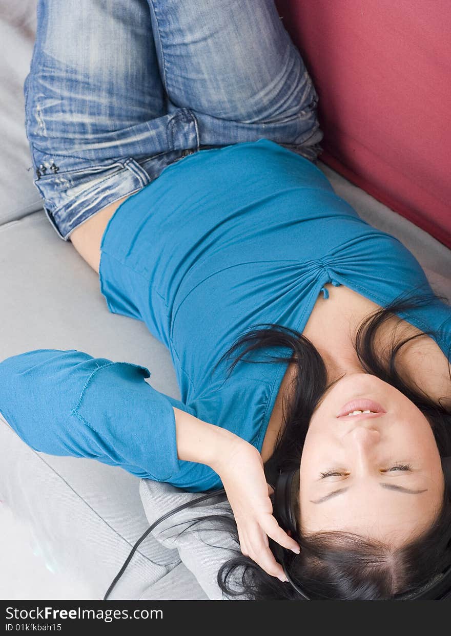 Young woman relaxing on red couch