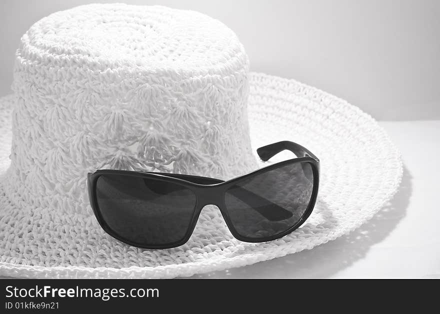 Hat with sunglasses, black and white photo. Hat with sunglasses, black and white photo