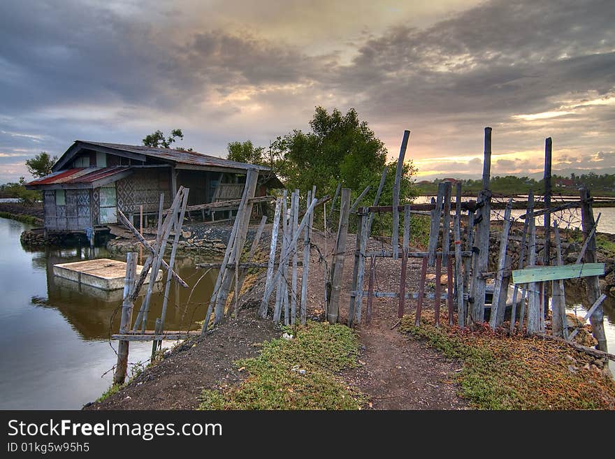 This simple house is located in the middle of fishponds in Barangay Babag, Lapu-lapu City, Cebu, Philippines. This HDR was taken during sunset. This simple house is located in the middle of fishponds in Barangay Babag, Lapu-lapu City, Cebu, Philippines. This HDR was taken during sunset.