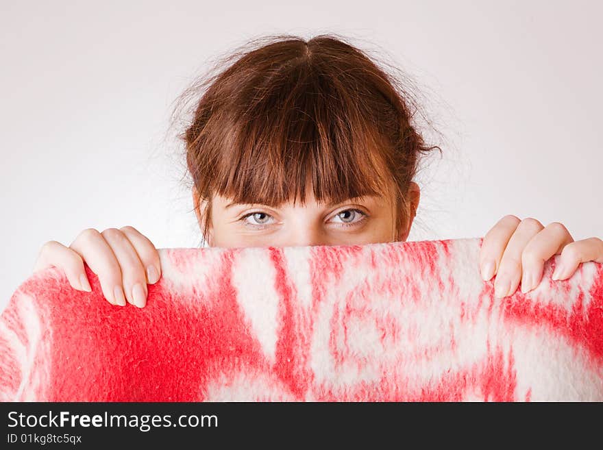 Girl face hiding behind a towel