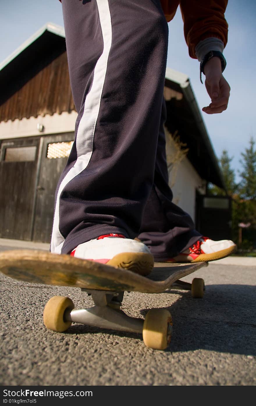 A young teen skateboarding and having fun in a suburban setting. A young teen skateboarding and having fun in a suburban setting.