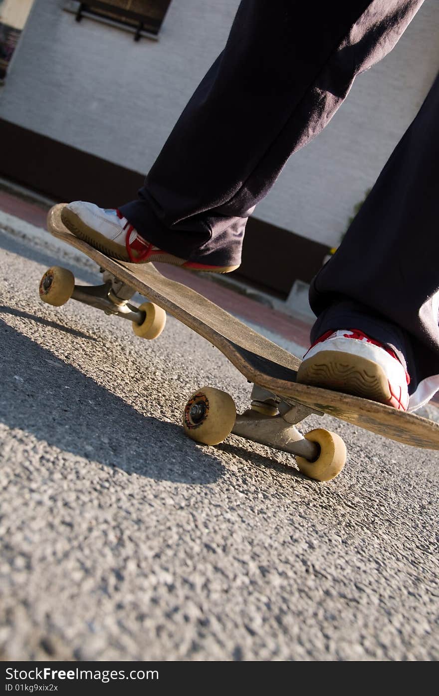 A young teen skateboarding and having fun in a suburban setting. A young teen skateboarding and having fun in a suburban setting.