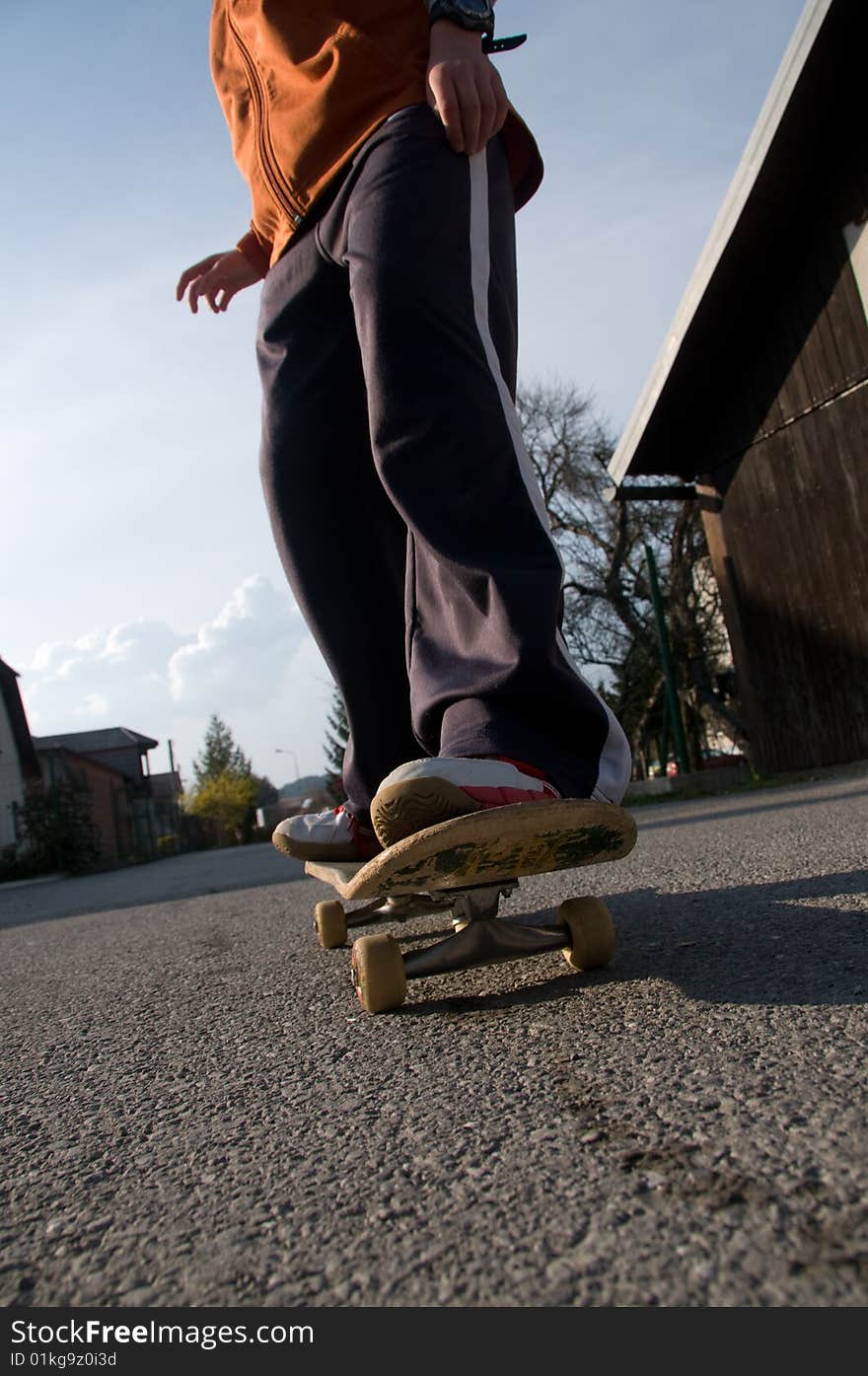 A young teen skateboarding and having fun in a suburban setting. A young teen skateboarding and having fun in a suburban setting.