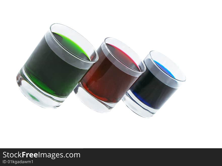 Three glasses with coloured cocktails isolated over white background. Three glasses with coloured cocktails isolated over white background