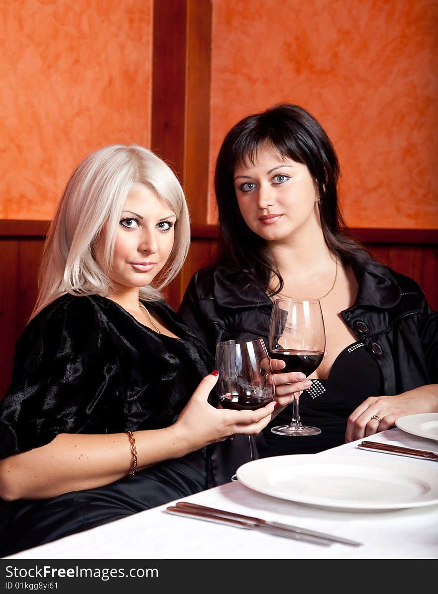 Two female friends sitting at a table in a restaurant