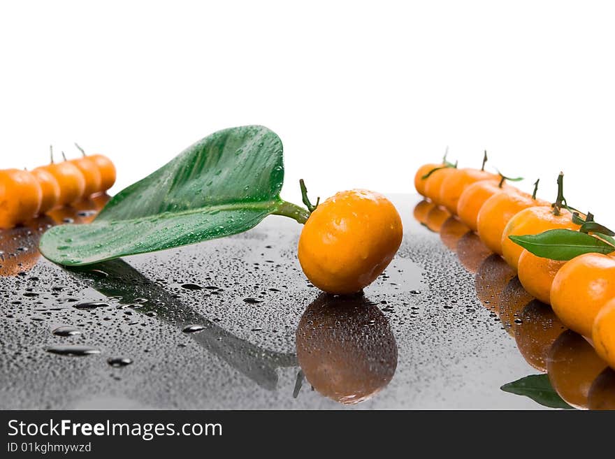 Tangerines lie in a row on the black