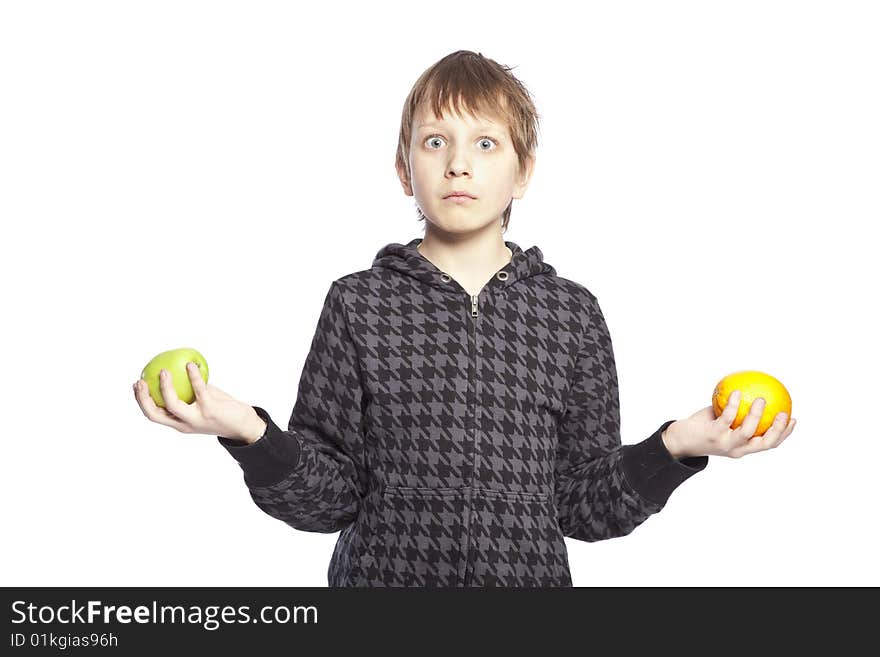 Isolated boy holding apple and orange over white background