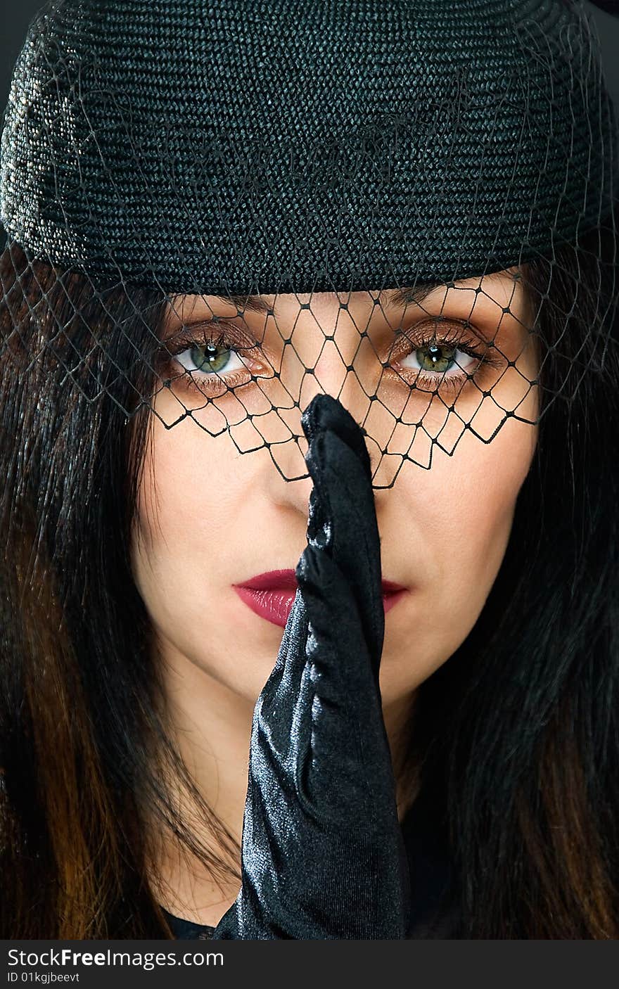 Portrait of young woman in black hat with veil. Portrait of young woman in black hat with veil