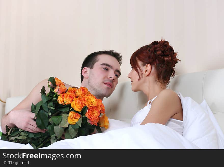 Young loving couple in relaxing bed