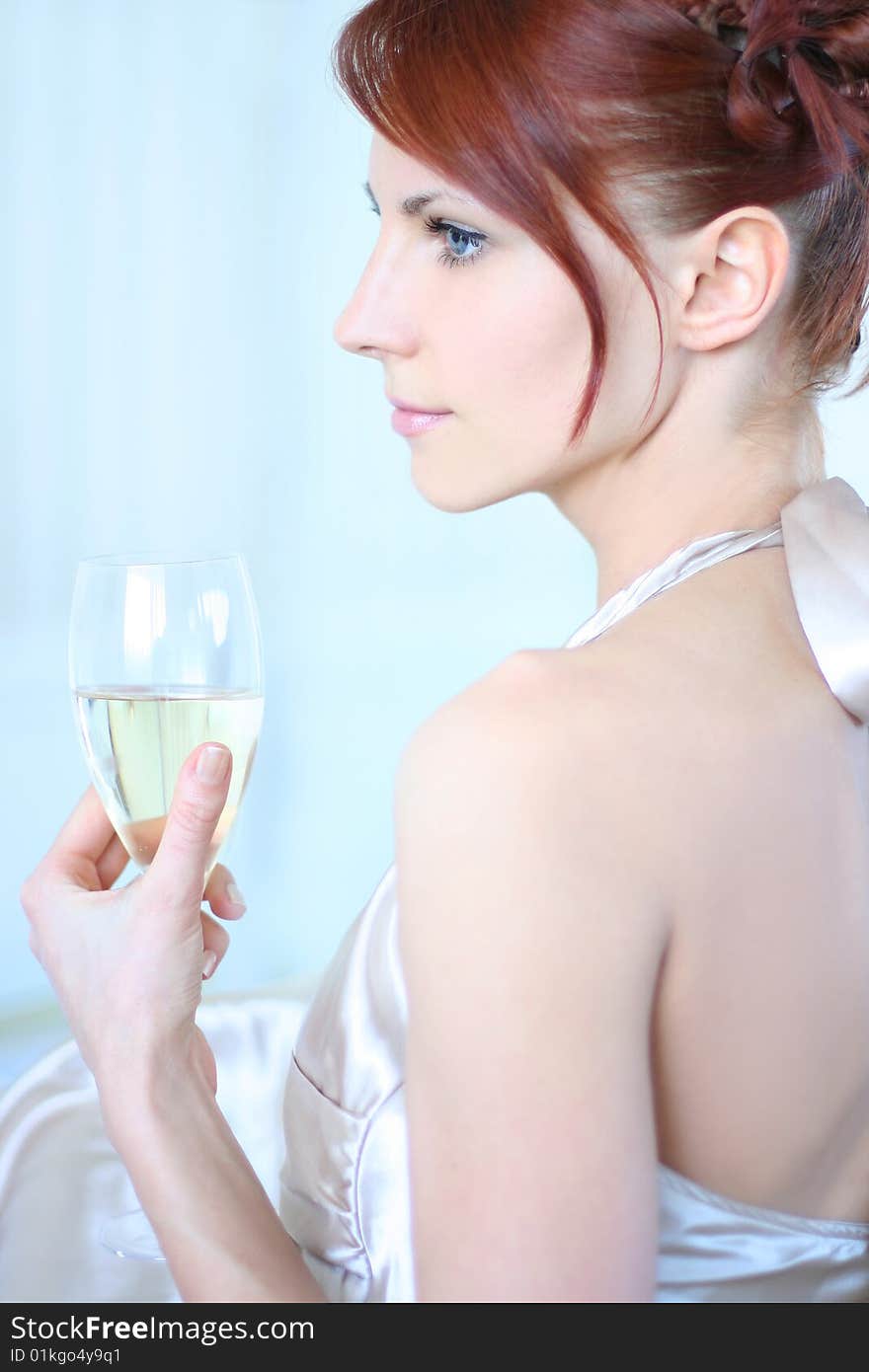 Beautiful young woman drinking champagne. Beautiful young woman drinking champagne