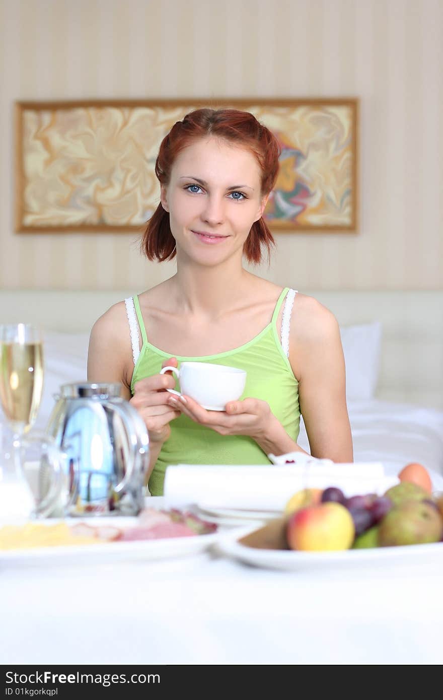 Cute young woman having breakfast