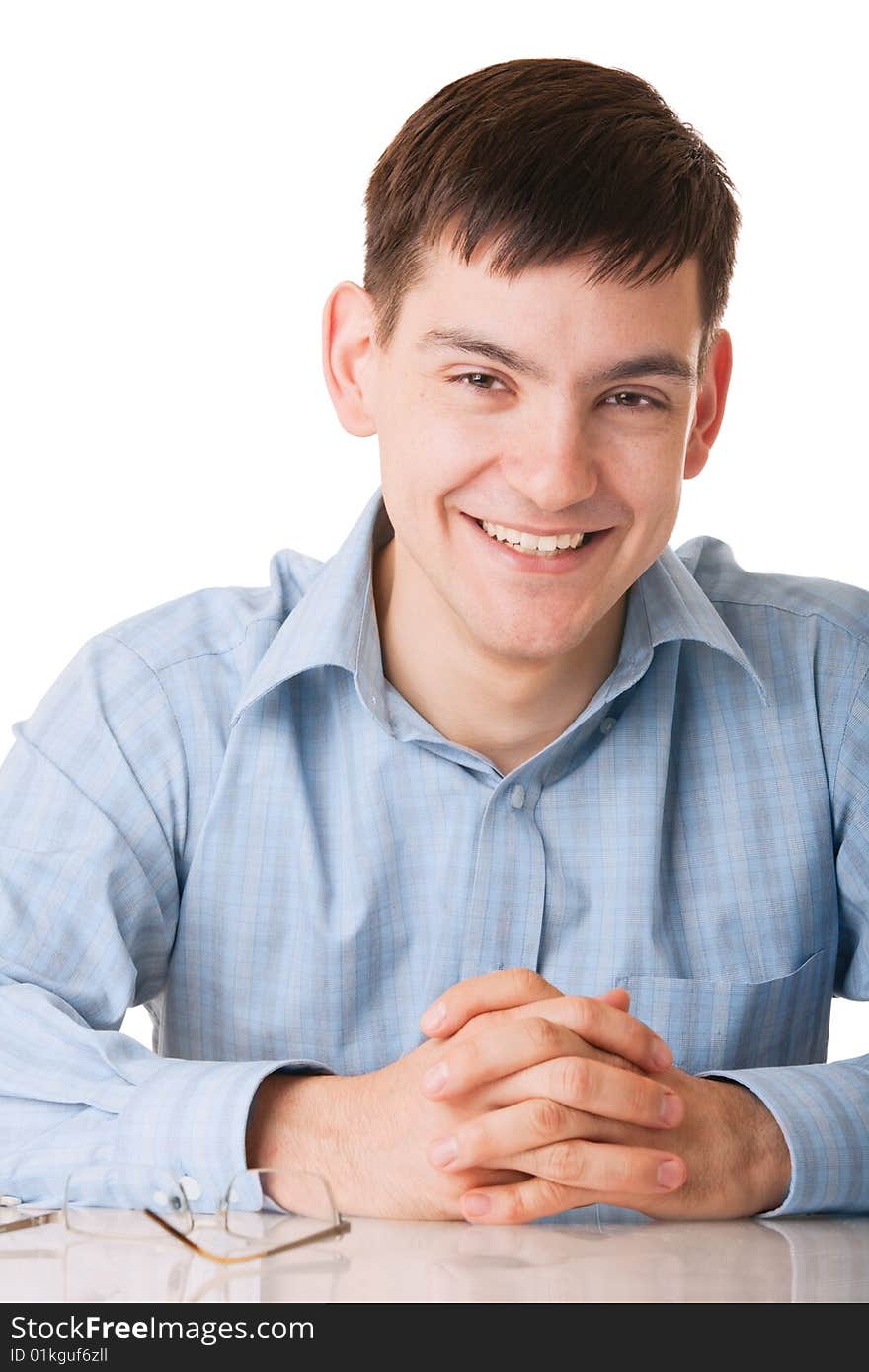 Young smiling man in blue shirt on white background