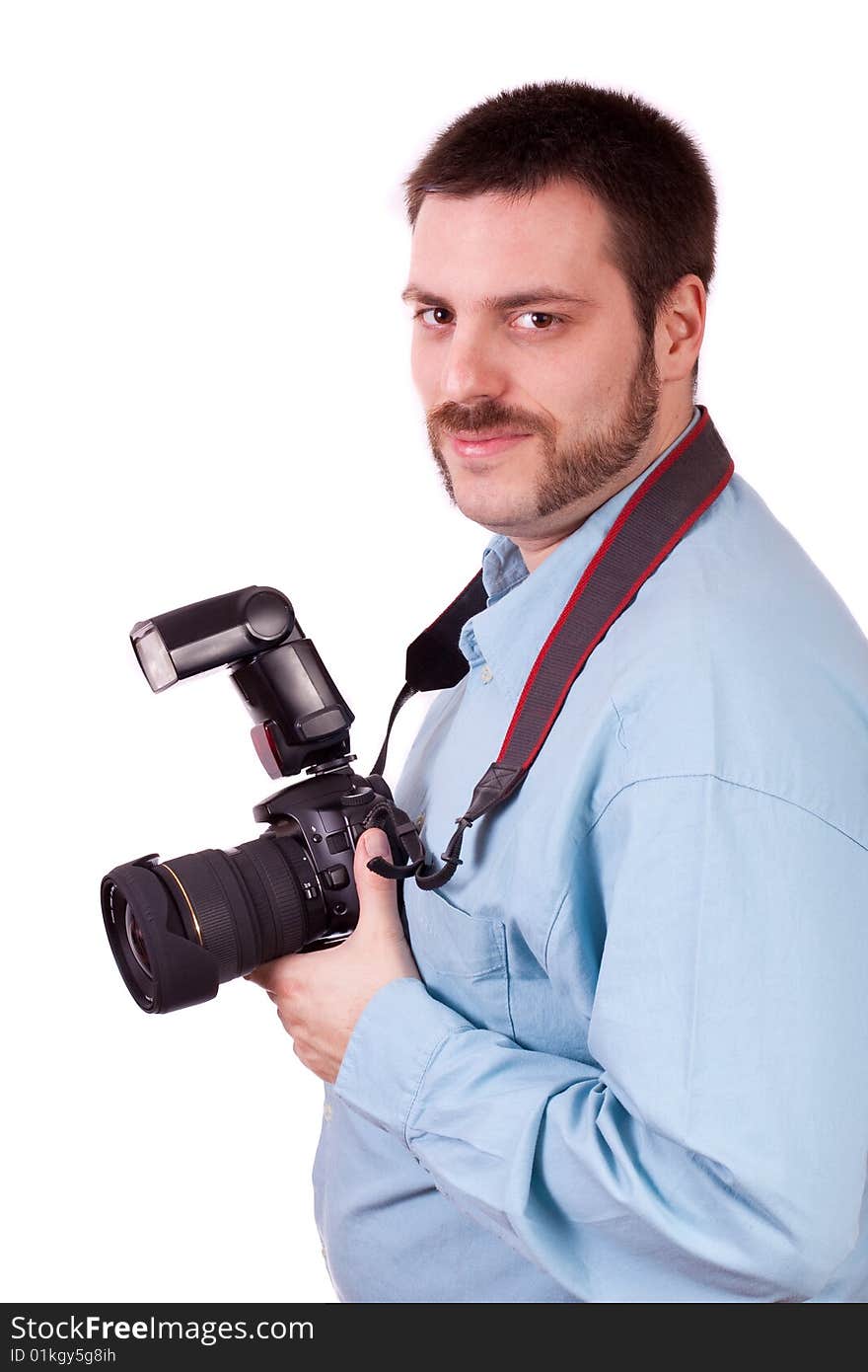 Young man holding SLR camera in his hand and smiling. Young man holding SLR camera in his hand and smiling