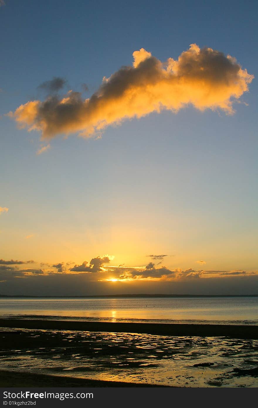 A Sunset over the sea with a cloud. A Sunset over the sea with a cloud