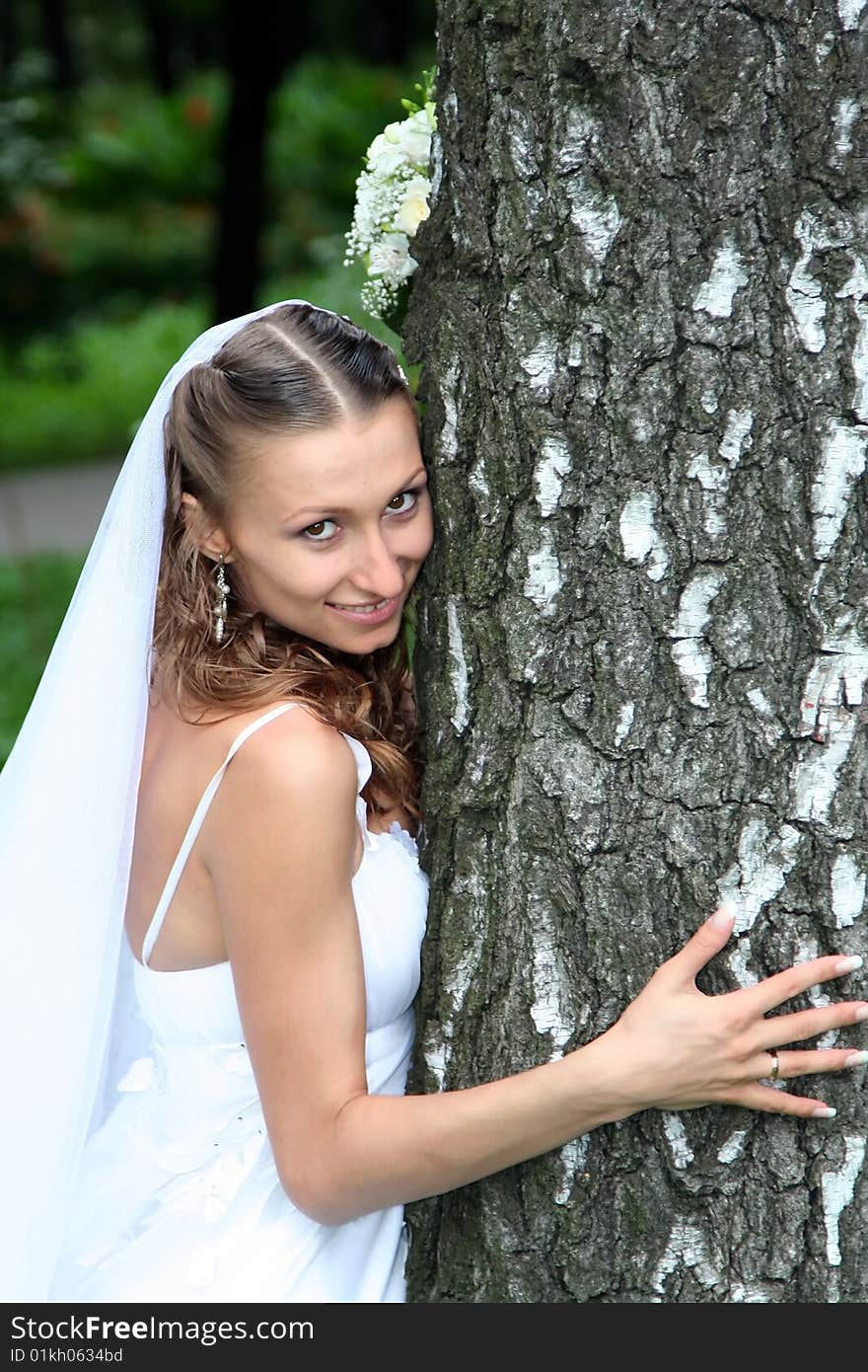 Young beautiful bride with wedding bouquet