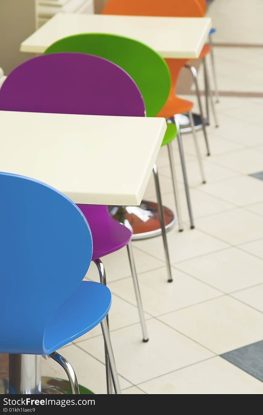 Coloured plastic furniture in a row. Coloured plastic furniture in a row