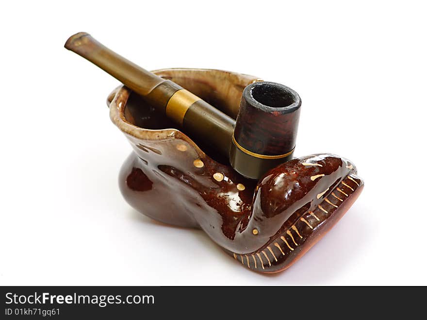 Pipe and ashtray on a white