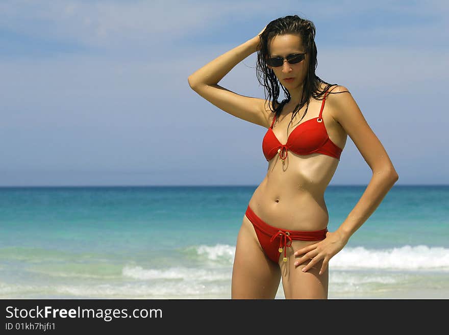 Woman in red bikinis on the beach. Woman in red bikinis on the beach