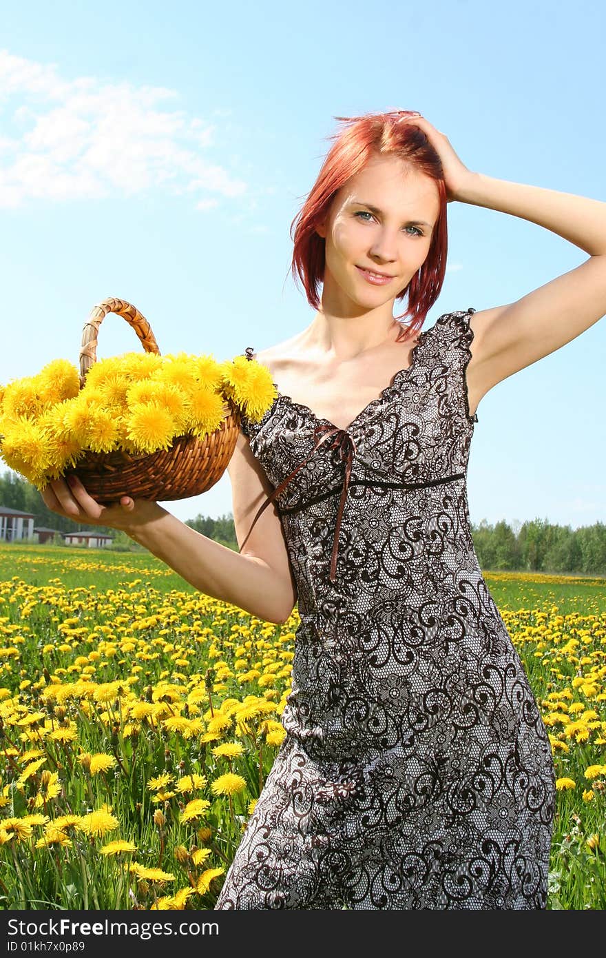 Beautiful redhead girl with basket of dandelions. Beautiful redhead girl with basket of dandelions