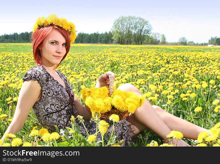 Beautiful redhead girl with basket of dandelions. Beautiful redhead girl with basket of dandelions