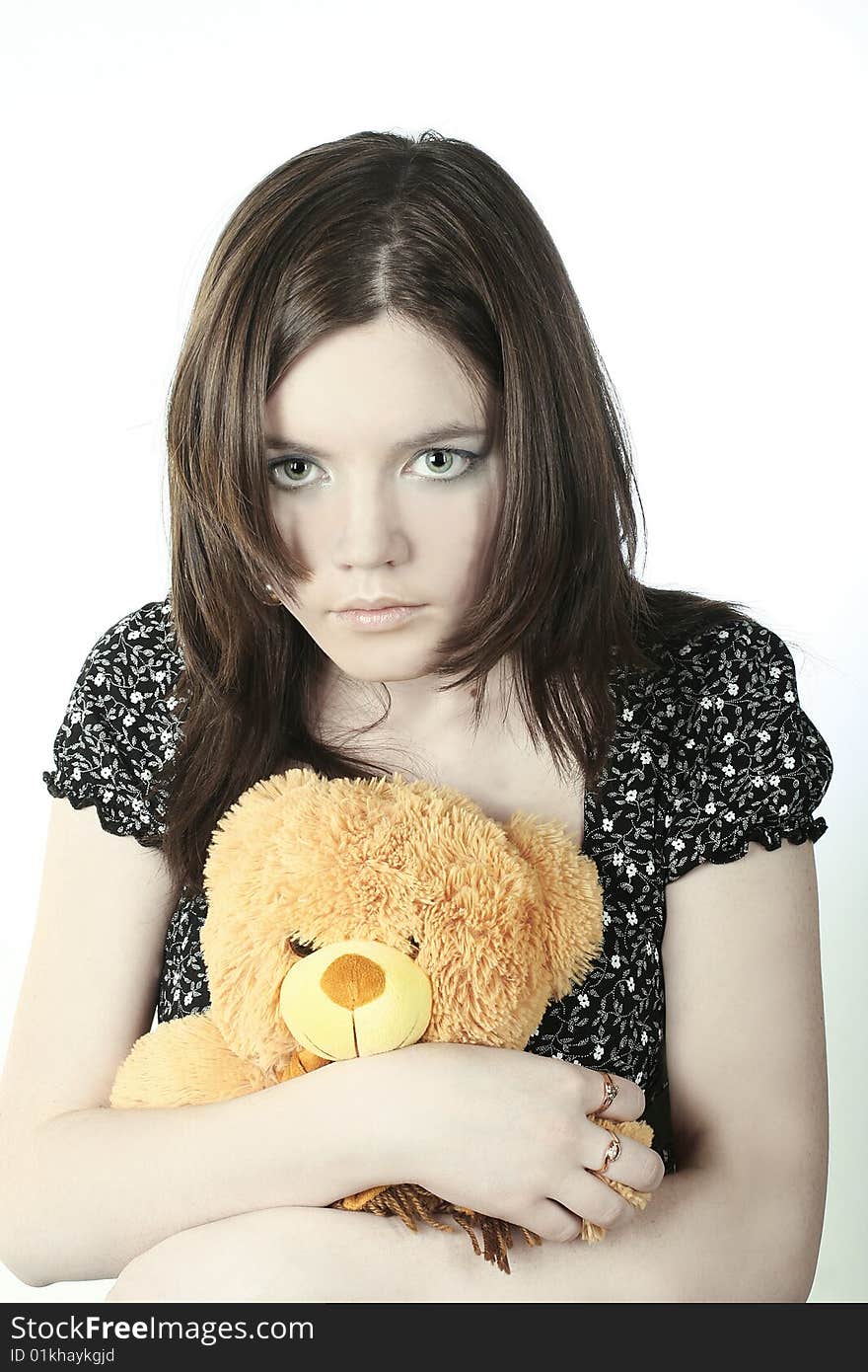 Romantic portrait of teen-girl with bear in her hands. Romantic portrait of teen-girl with bear in her hands.