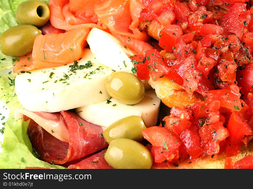 Delicious tomato salad with olives, mozzarella, smoked salmon and bacon. Delicious tomato salad with olives, mozzarella, smoked salmon and bacon