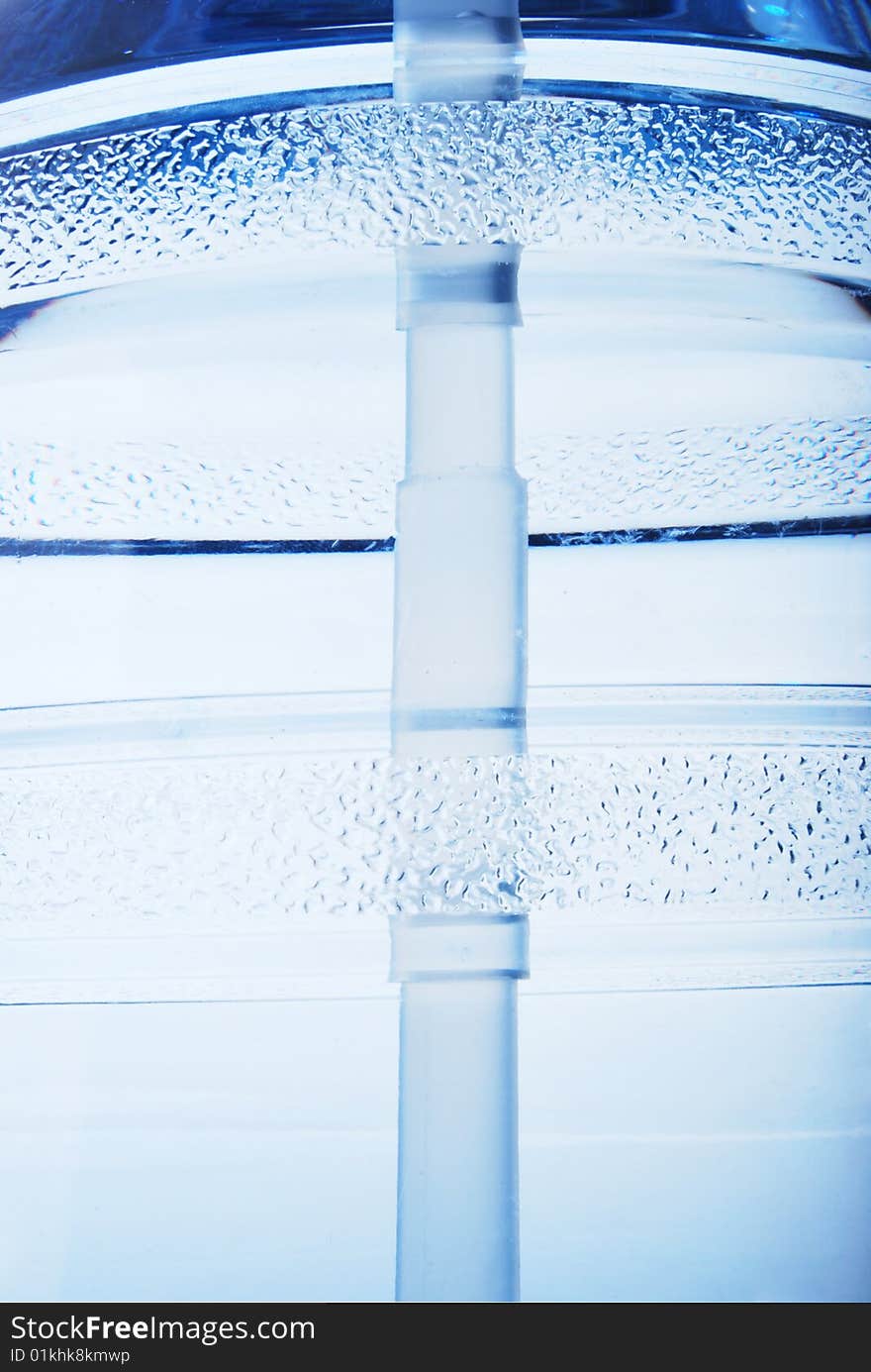 A large bottle of pure water on a white background detail. Studio work. A large bottle of pure water on a white background detail. Studio work.