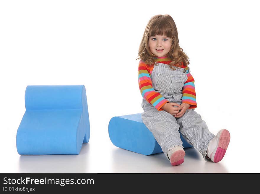 Beauty a little girl sitting on blue toy box