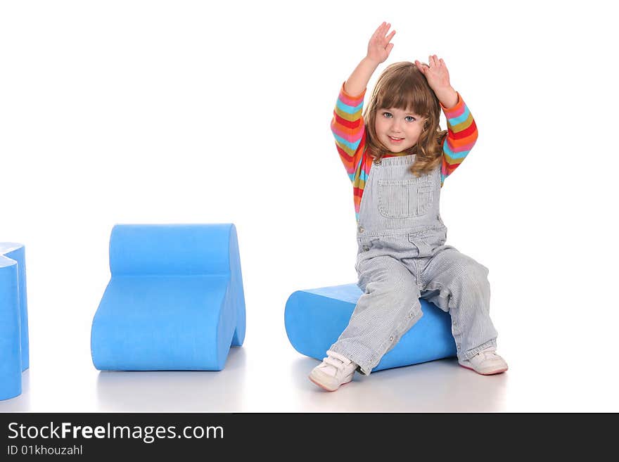 Beauty a little girl sitting on blue toy box