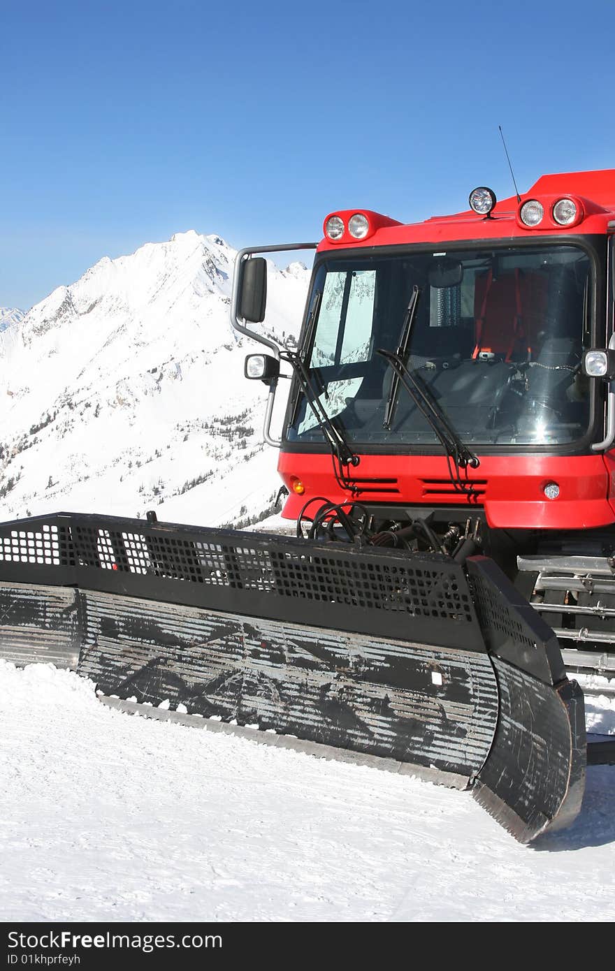 Snow-cat and mountain in winter