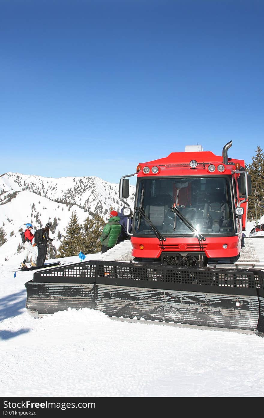 Snow-cat with skiers in winter