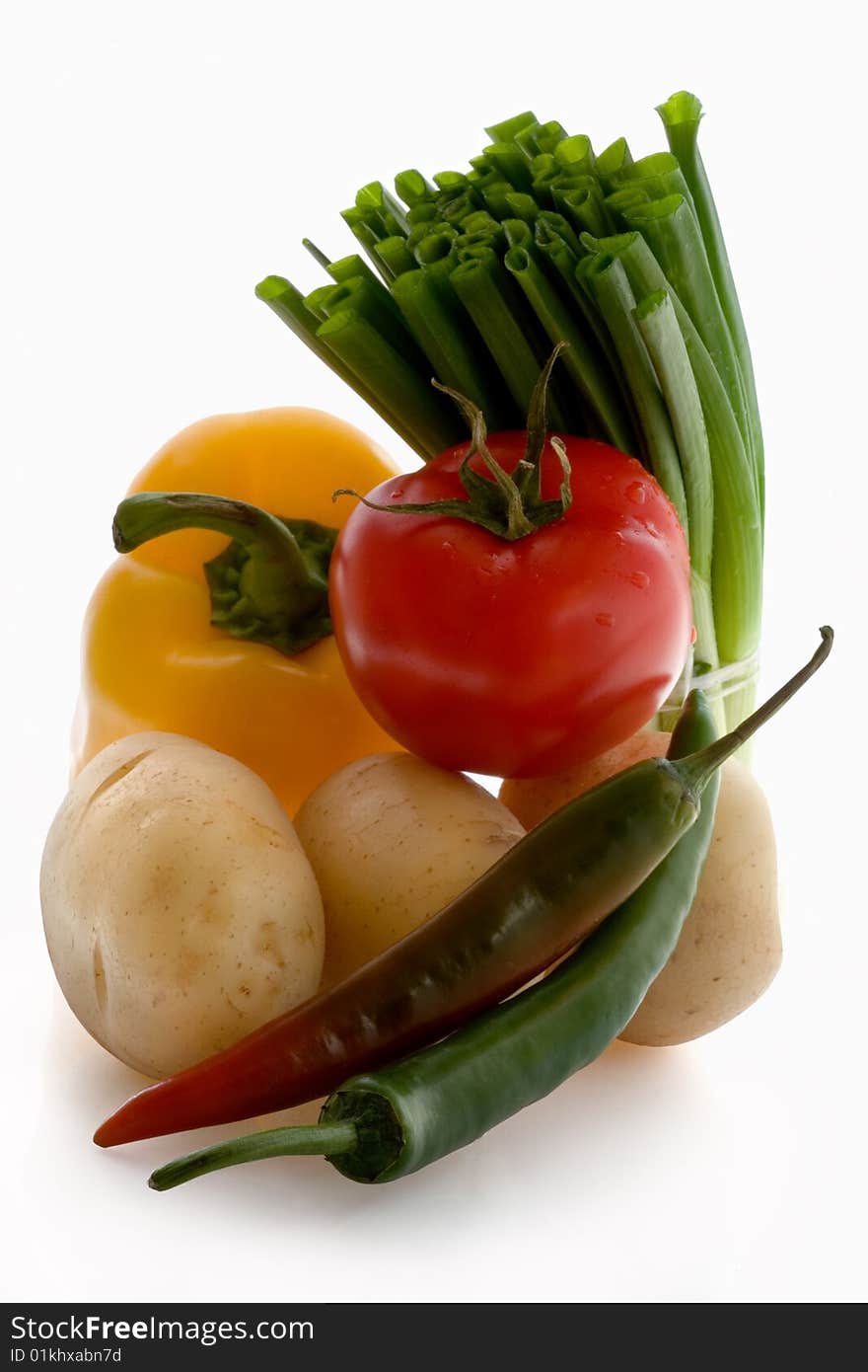 Tomato, garlic, pepper,  potatoes on a white background. Tomato, garlic, pepper,  potatoes on a white background