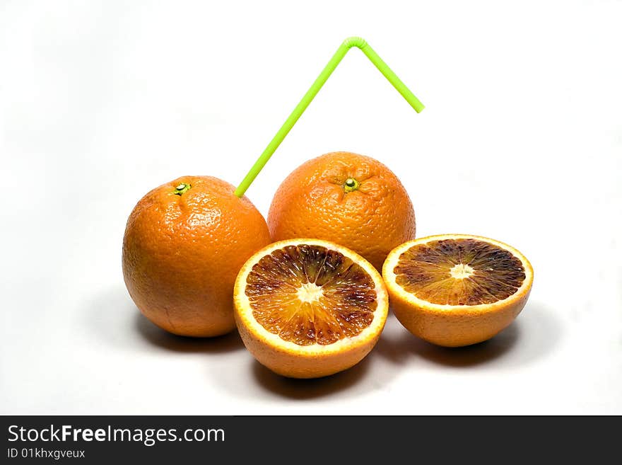 orange with straw on a white background. orange with straw on a white background