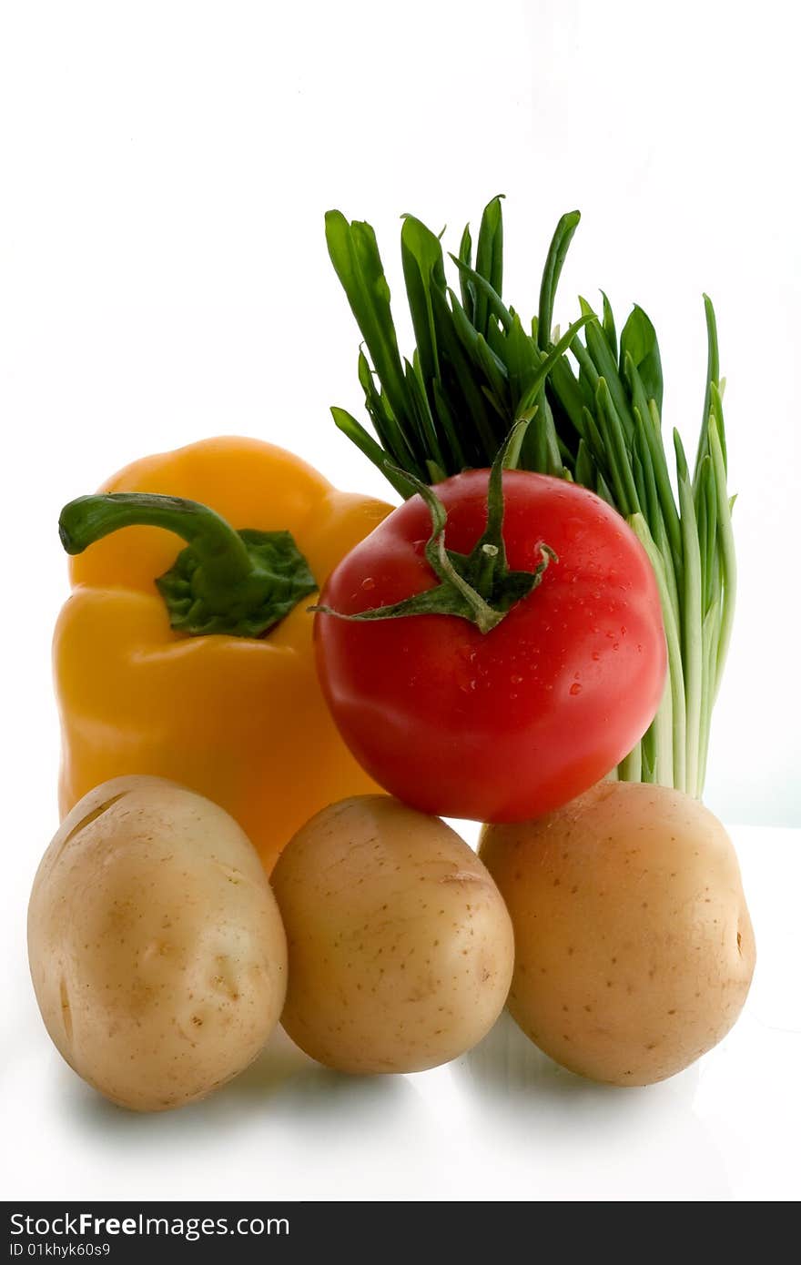 Tomato, garlic, pepper,  potatoes on a white background. Tomato, garlic, pepper,  potatoes on a white background