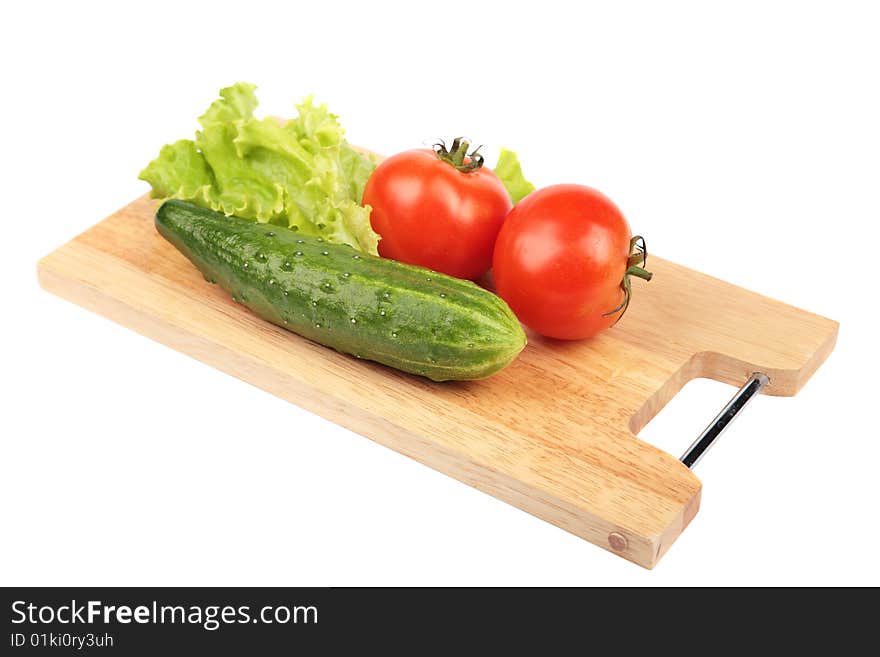 Vegetables on a wooden board on a white background