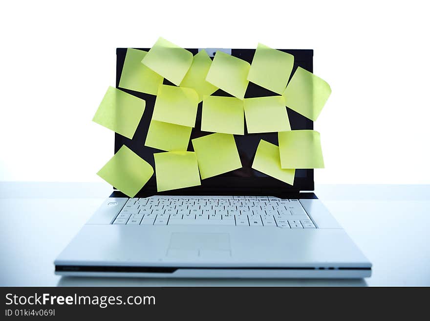 Close up of computer laptop on desk with lot of yellow notes on display. Close up of computer laptop on desk with lot of yellow notes on display