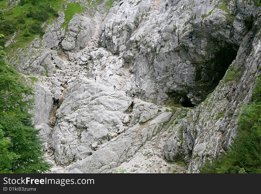 Group of people climbing a mountain near Zugspitze, Garmisch, in a streep path. Group of people climbing a mountain near Zugspitze, Garmisch, in a streep path