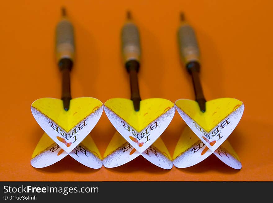 Three darts on red background