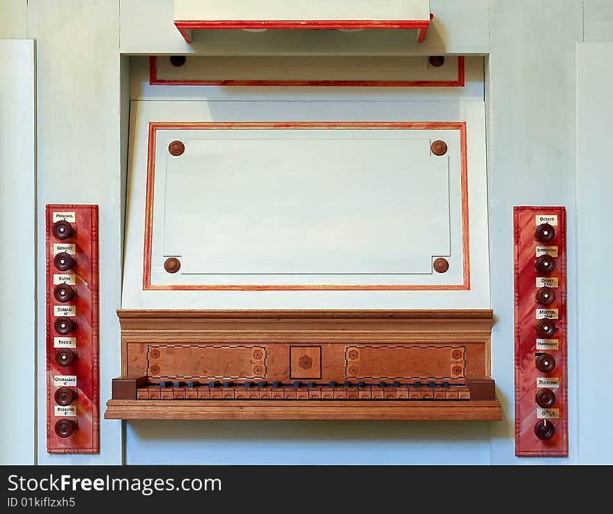 Old wooden organ controls and keyboard