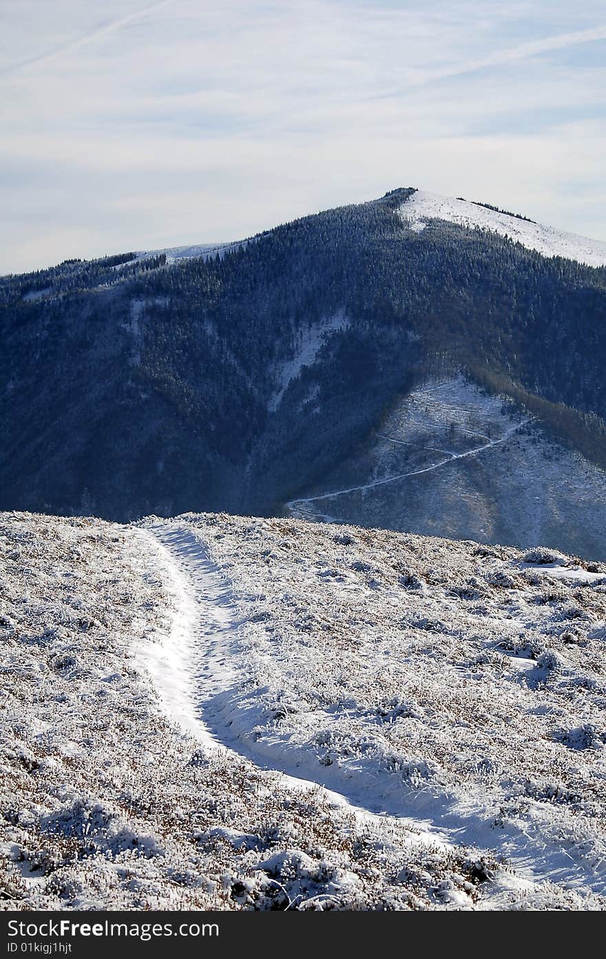 Mountain road in winter leading to mountain top. Mountain road in winter leading to mountain top