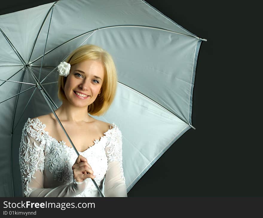 Portrait of young woman on black background with umbrella. Portrait of young woman on black background with umbrella