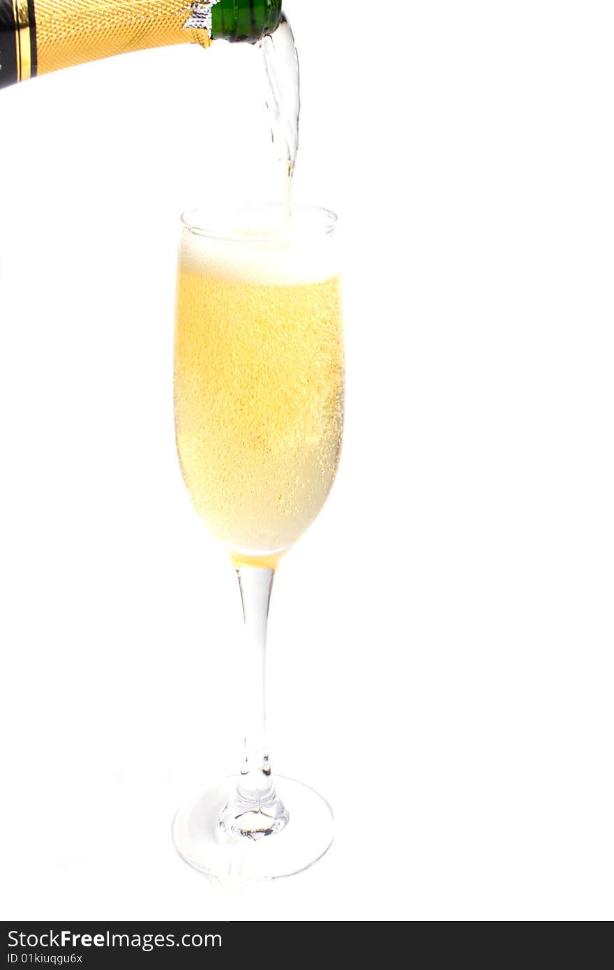 Champagne being poured into glass isolated on white background.