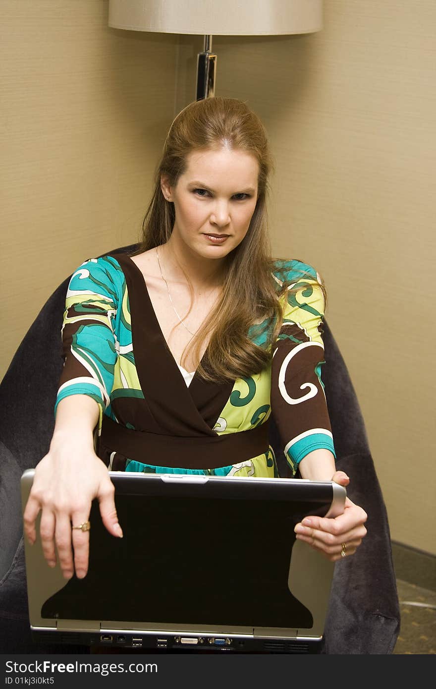 Young Female Sitting with Laptop Computer on Chair